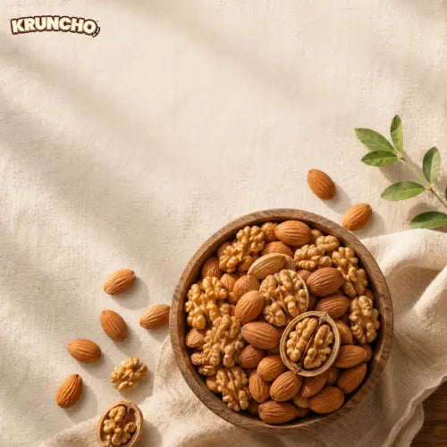 A round wooden bowl filled with walnuts and almonds resting on a textured beige cloth, with scattered nuts on the side under soft sunlight.
