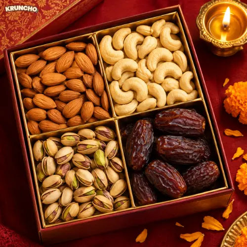 Close-up of an open Diwali dry fruit gift box with a diya and marigold petals