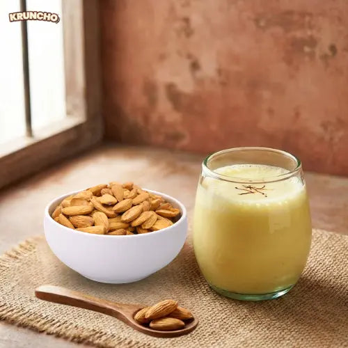 A bowl of premium Mamra badam with a glass of saffron lassi, a popular healthy snack in India