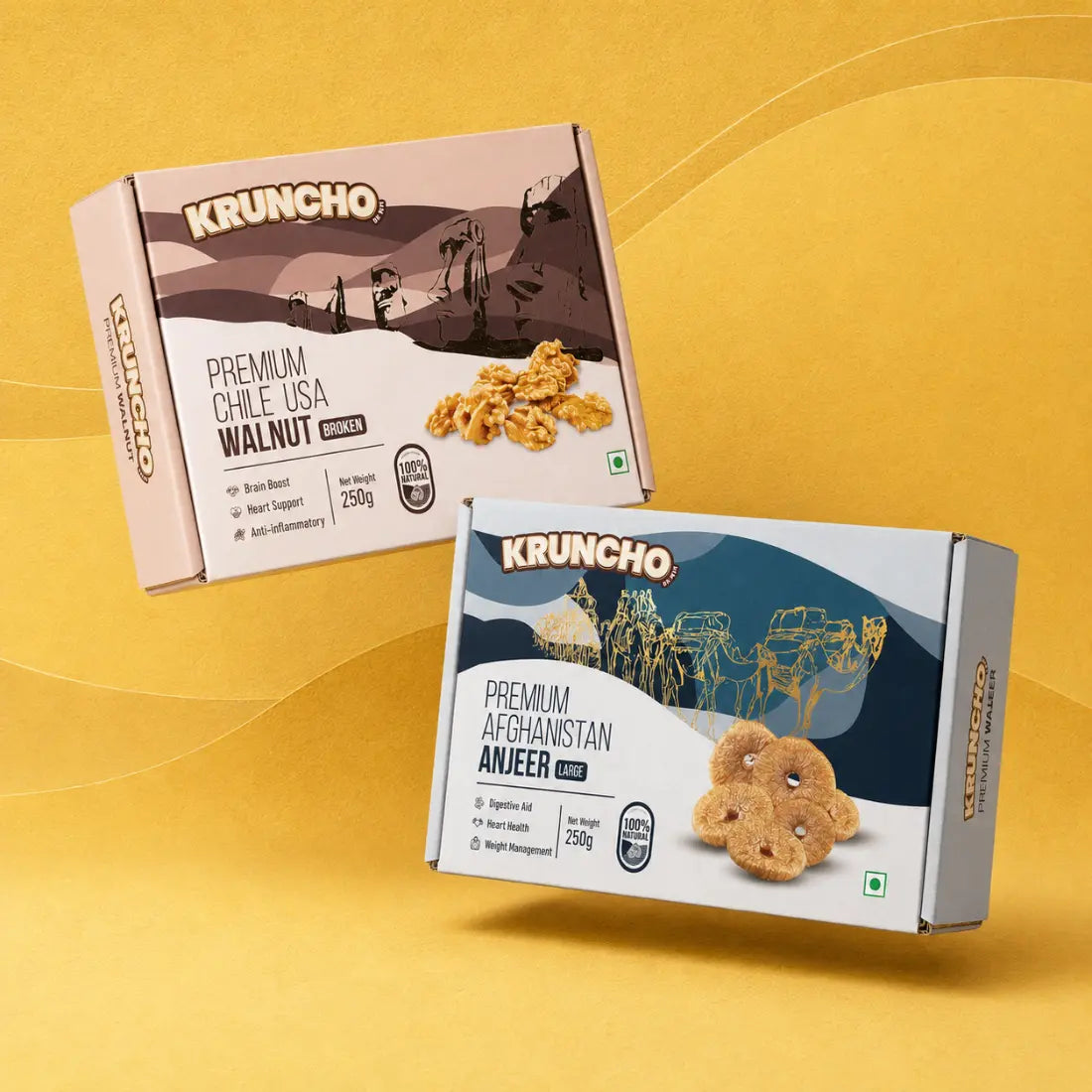 Two premium KRUNCHO brand product boxes floating against a yellow background: one containing broken Chile USA walnuts and the other containing large Afghanistan anjeer (figs).