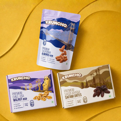 A flat lay of Kruncho premium packaged healthy snacks, including California almonds, walnuts, and Safawi dates.