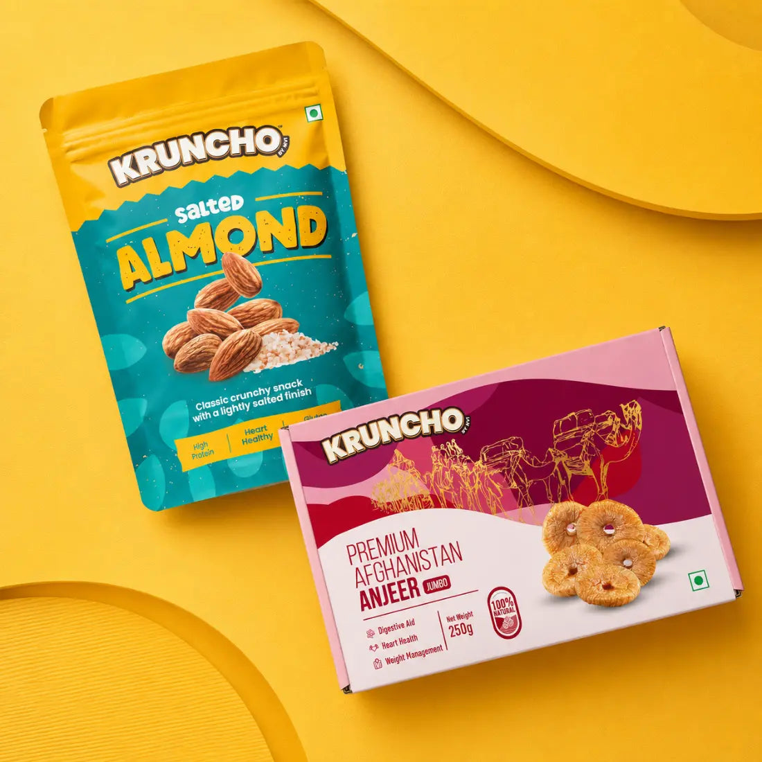 Kruncho healthy snacks featuring salted almonds and premium Afghanistan jumbo anjeer on a yellow background.