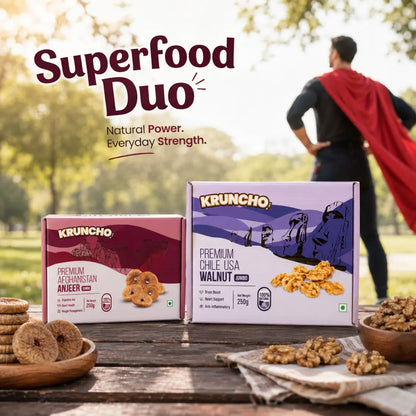 Kruncho brand 250g boxes of Jumbo Afghanistan Anjeer and Jumbo Chile USA Walnuts sitting on a picnic table under the text 'Superfood Duo: Natural Power. Everyday Strength.