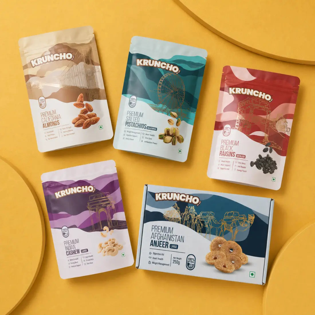 Kruncho dry fruits range featuring four colorful pouches of almonds, pistachios, raisins, and cashews alongside a box of dried Afghanistan Anjeer figs.