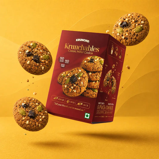 Kruncho Krunchables Classic Millet Cookie box and single pack with jowar, ragi and oats cookies on a plate outdoors
